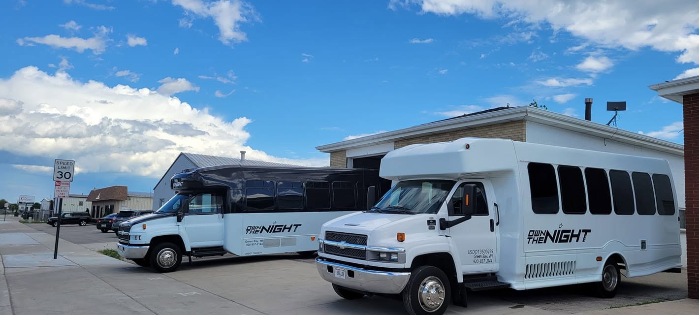 The limo bus and shuttle parked side by side
