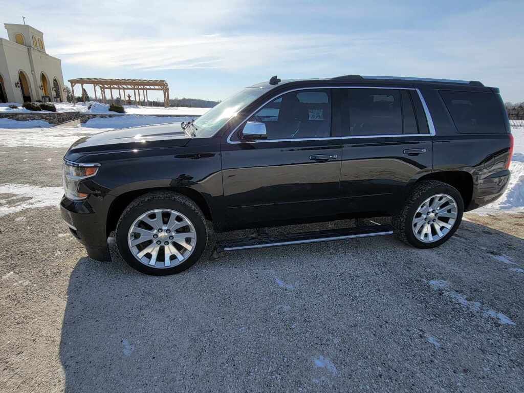 Black Chevrolet Tahoe parked in the snow.