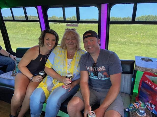 Guests riding between stops with drinks in hand.